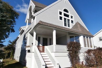 Inspiration for a large timeless gray two-story wood gable roof remodel in Boston