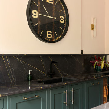 Deep green kitchen with warm metallic accents