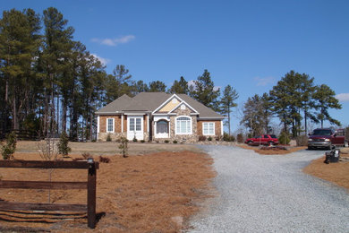 Inspiration for a mid-sized timeless beige one-story mixed siding gable roof remodel in Raleigh
