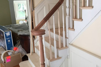 Inspiration for a wooden l-shaped staircase remodel in Boston with painted risers