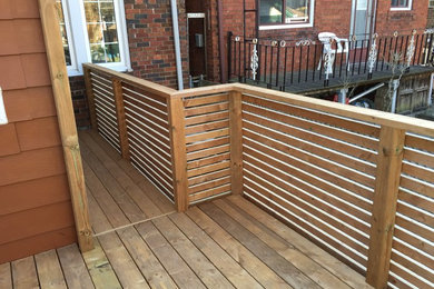 Inspiration for a small modern backyard deck remodel in Toronto with a pergola