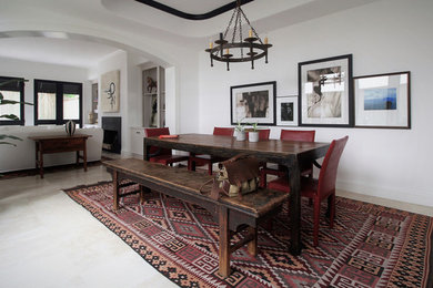 Enclosed dining room - large transitional travertine floor enclosed dining room idea in Los Angeles with white walls and no fireplace