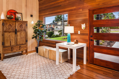Photo of a contemporary foyer in Seattle with medium hardwood floors, a single front door and a medium wood front door.