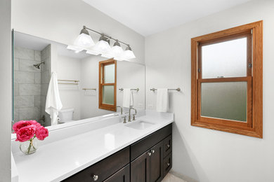 Example of a kids' porcelain tile, gray floor and single-sink bathroom design in Chicago with dark wood cabinets, an undermount sink, quartzite countertops and white countertops