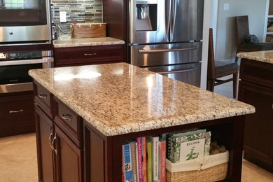 Example of a large transitional beige floor kitchen design in Orange County with dark wood cabinets, granite countertops, multicolored backsplash, matchstick tile backsplash, stainless steel appliances, two islands, an undermount sink and shaker cabinets