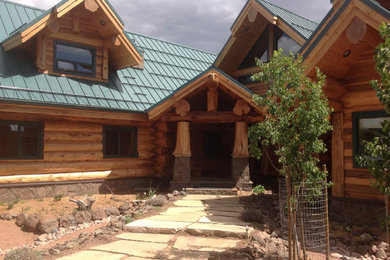 Large rustic brown two-story wood exterior home idea in Phoenix with a metal roof