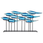 ELK Group - Tultui Ice Blue Table Art - Blue - Brilliant rays of morning sun have sent a hot white streak of light along the Neon Blue scales of this scurrying school of Damsels, their elongated silhouettes becoming a blur, resembling ice or mercury. Introducing our hand crafted Tultui Series Metal Table Art: Whose exquisite color and graceful lines are right at home in any high-concept office, kitchen, or entryway. Distinctive Jet Black footed stand.