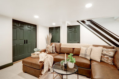 Inspiration for a mid-sized contemporary underground carpeted and beige floor basement remodel in Other with white walls and a corner fireplace
