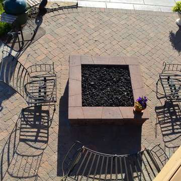 Comfortable backyard retreat with fire pit, paver patio and pool design