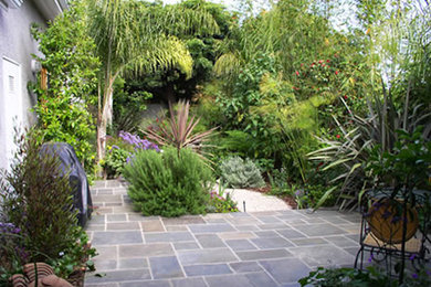 Photo of a large partial sun backyard concrete paver garden path in Phoenix.
