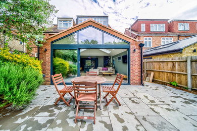 Photo of a contemporary back patio in London.