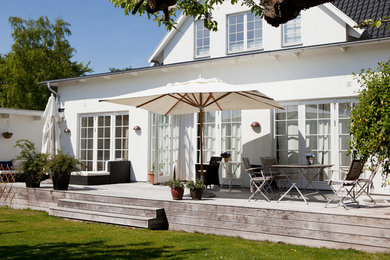 This is an example of a large traditional side yard deck in Malmo.