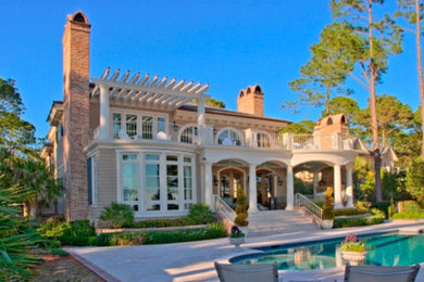 Large traditional beige two-story wood exterior home idea in Atlanta with a hip roof