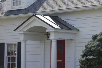 Example of a mid-sized classic white two-story concrete fiberboard exterior home design in DC Metro with a metal roof