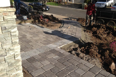 This is an example of a small modern full sun front yard concrete paver driveway in Portland for summer.