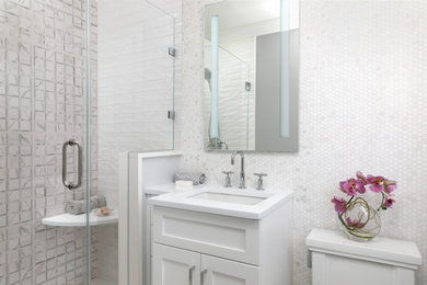 Example of a small trendy master white tile and porcelain tile porcelain tile, gray floor and single-sink bathroom design in Newark with shaker cabinets, white cabinets, a two-piece toilet, white walls, an undermount sink, quartz countertops, a hinged shower door, white countertops and a built-in vanity