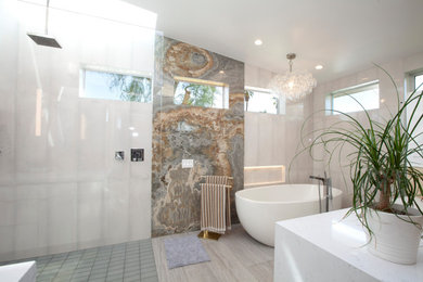 Mid-sized minimalist master gray tile and porcelain tile porcelain tile and gray floor bathroom photo in Other with flat-panel cabinets, white cabinets, white walls, a drop-in sink, quartzite countertops and white countertops