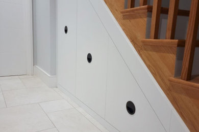 Modern under stairs storage with black handles