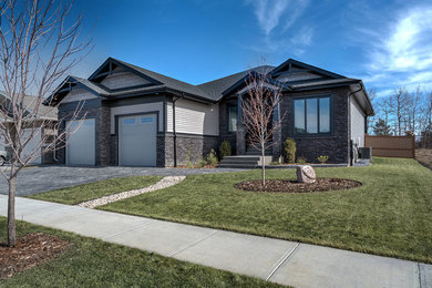 Inspiration for a mid-sized transitional one-story house exterior remodel in Edmonton with a shingle roof