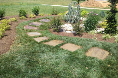 Design ideas for a traditional side yard stone landscaping in Other.