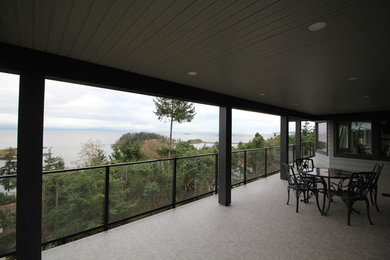 Deck - large modern backyard deck idea in Other