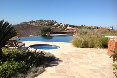 Inspiration for a mid-sized southwestern backyard tile patio kitchen remodel in San Diego with no cover