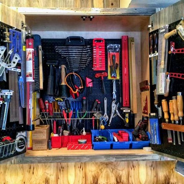 A beautiful wooden, rustic pegboard cabinet outfitted with Wall Control’s Blac
