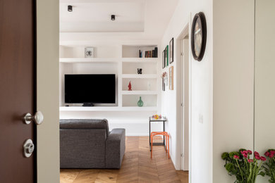 Example of a trendy light wood floor and tray ceiling entryway design in Cagliari with white walls and a white front door