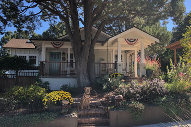 Small craftsman gray one-story wood and board and batten exterior home idea in Other with a shingle roof and a brown roof