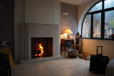 Design ideas for a mid-sized traditional open concept living room in Saint-Etienne with a stone fireplace surround, beige floor and a standard fireplace.