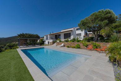 Idée de décoration pour un grand piscine avec aménagement paysager avant marin rectangle avec des pavés en pierre naturelle.