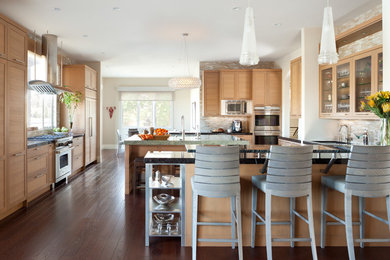 Inspiration for a large transitional u-shaped dark wood floor eat-in kitchen remodel in Denver with shaker cabinets, light wood cabinets, granite countertops, beige backsplash, glass tile backsplash, stainless steel appliances and an island