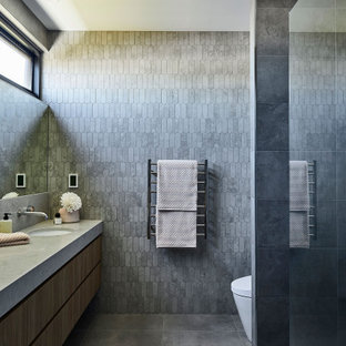 Large contemporary master bathroom in Geelong with flat-panel cabinets, dark wood cabinets, gray tile, mosaic tile, grey walls, cement tiles, an undermount sink, engineered quartz benchtops, grey floor, an open shower, grey benchtops, a single vanity and a floating vanity.