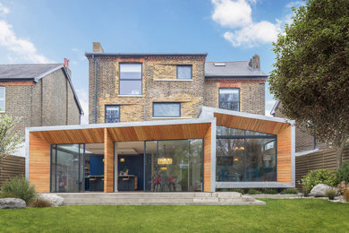 Inspiration for a large modern detached house in London with three floors and mixed cladding.