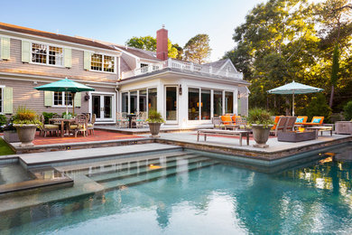Inspiration for a mid-sized contemporary backyard concrete and custom-shaped lap hot tub remodel in Boston