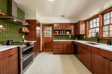 Eat-in kitchen - mid-sized transitional l-shaped eat-in kitchen idea in Columbus with shaker cabinets, medium tone wood cabinets, quartz countertops, green backsplash, subway tile backsplash and white countertops