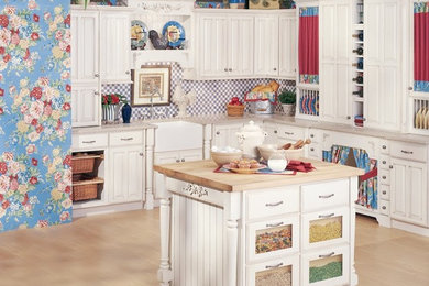 Inspiration for a cottage l-shaped enclosed kitchen remodel in New York with a farmhouse sink, raised-panel cabinets, white cabinets and a peninsula