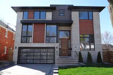 This is an example of a large modern three-storey multi-coloured house exterior in Toronto with mixed siding.