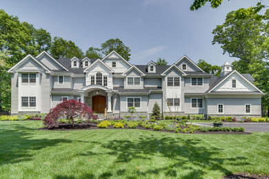 Example of a large transitional gray two-story wood exterior home design in New York with a mixed material roof