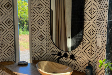 Mid-sized cottage master black and white tile and ceramic tile terra-cotta tile, orange floor, single-sink, exposed beam and wood wall bathroom photo in Hawaii with open cabinets, beige cabinets, a bidet, white walls, a vessel sink, wood countertops, beige countertops, a niche and a floating vanity