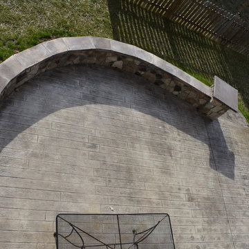 Stone walls, build in fire pit, and plank pattern stamped concrete