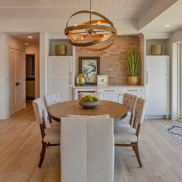 Contemporary Dining Room with a Rustic Brick Accent Wall and Modern Elegance