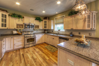 Example of a farmhouse medium tone wood floor kitchen design in New York with a double-bowl sink, shaker cabinets, quartz countertops, stainless steel appliances and an island