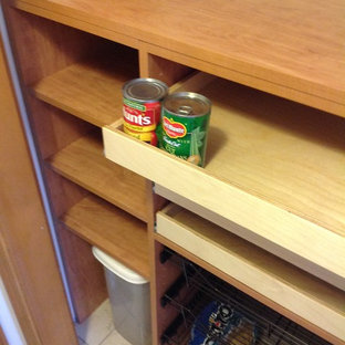 Small traditional kitchen pantry designs - Kitchen pantry - small traditional single-wall kitchen pantry idea in Manchester with open cabinets, medium tone wood cabinets and no island