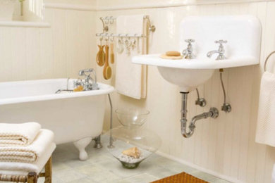 Photo of a mid-sized traditional master bathroom in Providence with a claw-foot tub, beige tile, brown tile, orange tile, ceramic tile, a wall-mount sink, white walls, slate floors and grey floor.