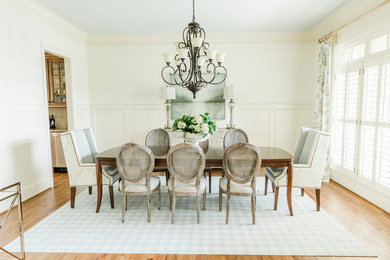 Example of a mid-sized country medium tone wood floor and brown floor kitchen/dining room combo design in Other with beige walls