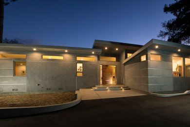 Mid-sized trendy gray one-story stucco exterior home photo in San Francisco with a shed roof