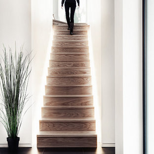 Inspiration for a contemporary wood staircase in Hampshire with wood risers.