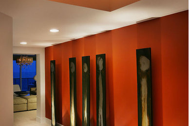 Design ideas for a large modern hallway in Miami with orange walls.
