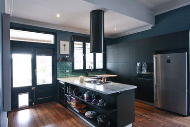 Design ideas for a mid-sized modern u-shaped eat-in kitchen in Melbourne with a drop-in sink, flat-panel cabinets, black cabinets, marble benchtops, green splashback, ceramic splashback, stainless steel appliances, medium hardwood floors, with island, brown floor and white benchtop.
